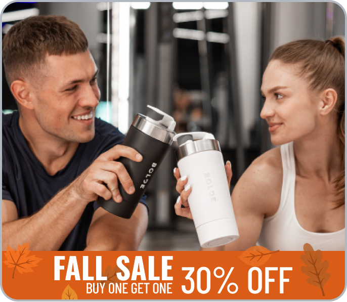 Two athletes holding BOLDE stainless steel shaker bottles at the gym
