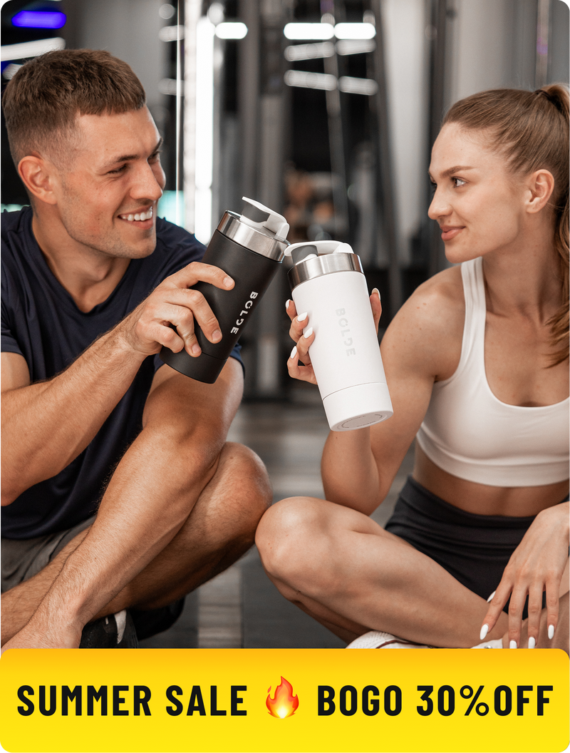 Two athletes holding BOLDE stainless steel shaker bottles at the gym